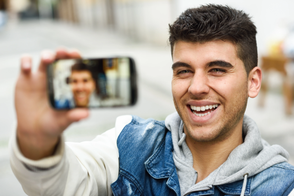 smiling-guy-taking-photo