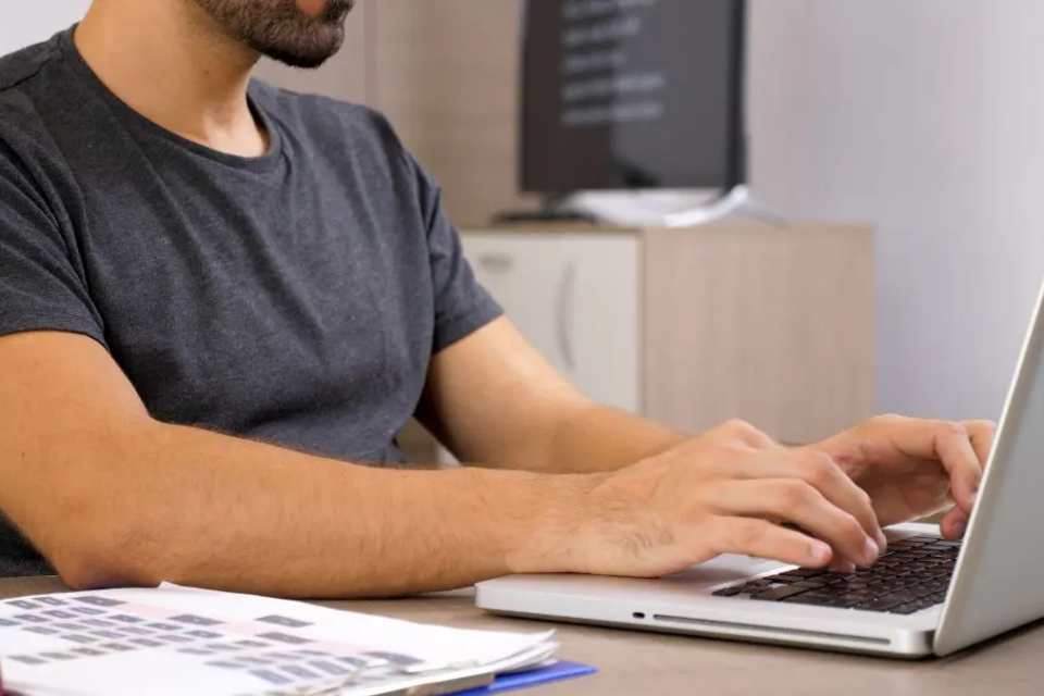 young-man-working-with-laptop-his-business-documentation-business-person-workplace-1787606064