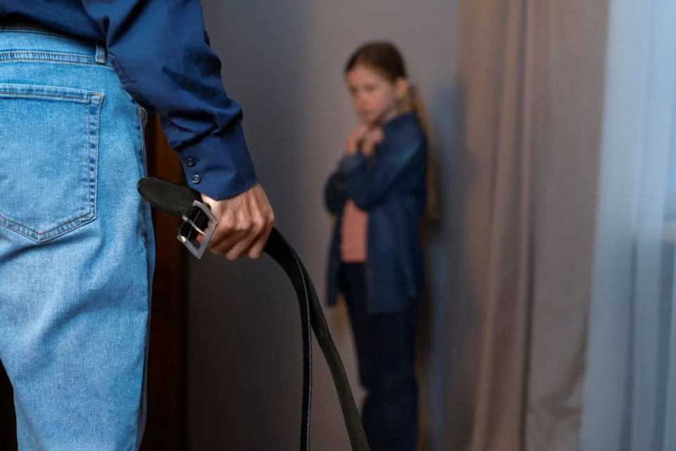 young-child-suffering-abuse-by-parent-with-belt-1789911889