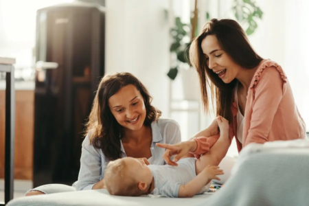 young-female-couple-playing-with-their-baby-son-having-fun-home